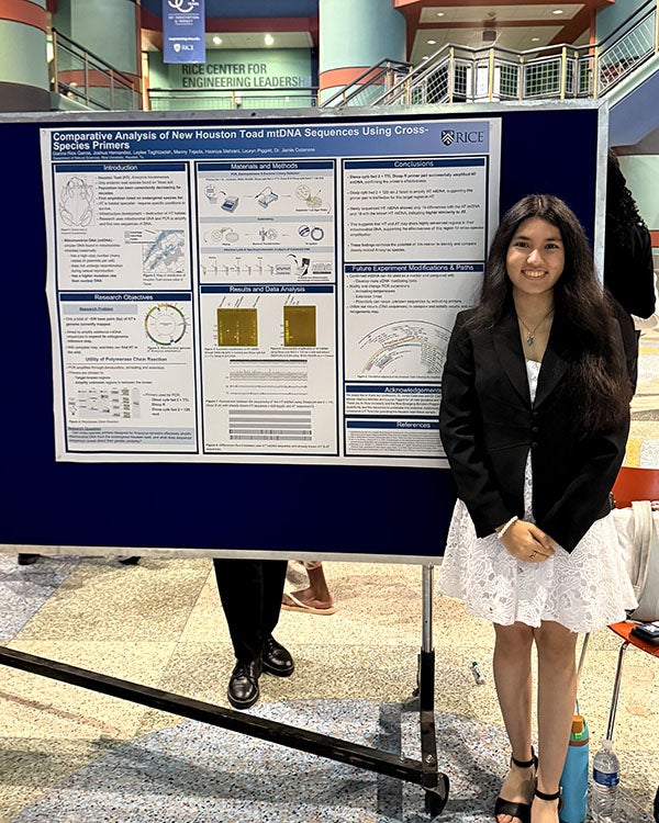 A girl standing in front of a science research poster