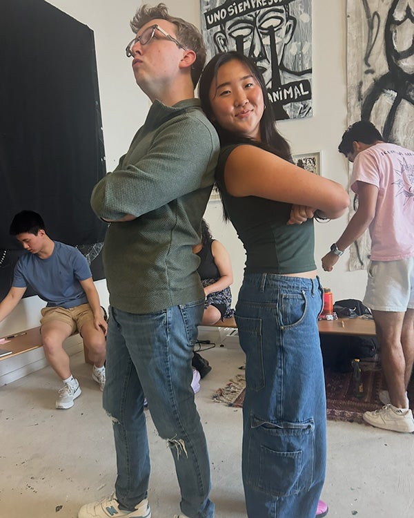 Two people standing back-to-back