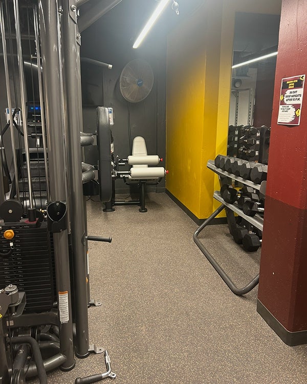 A dimly lit gym with large equipment 