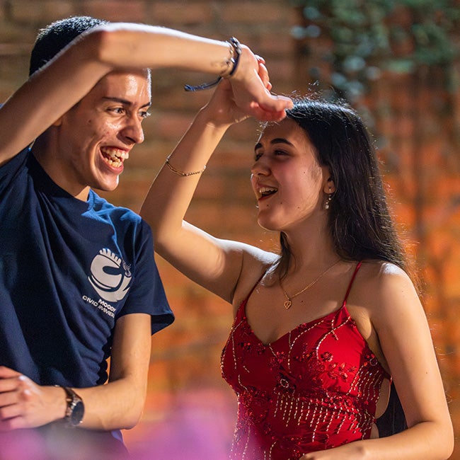 A guy and girl dancing together happily