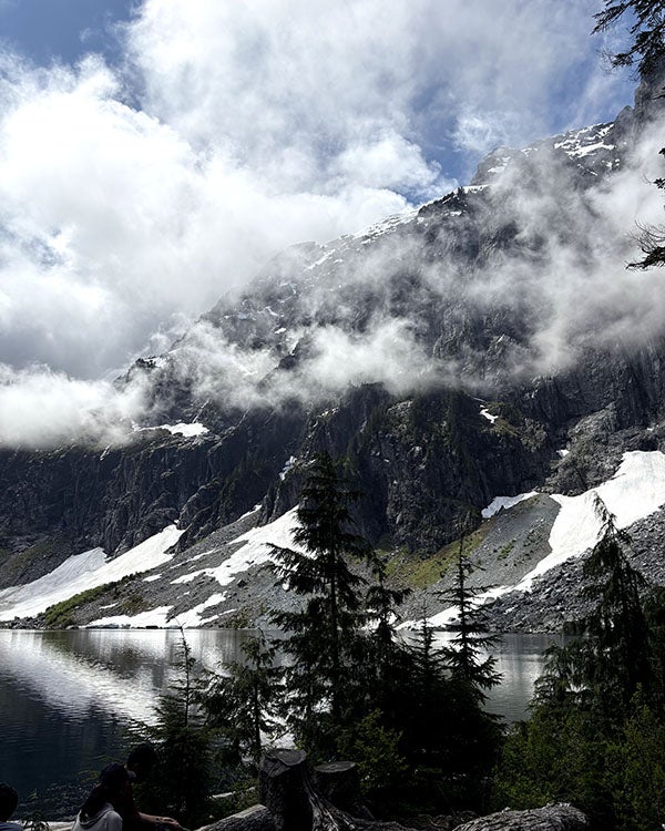 clouds shrouding view of a vast mountain