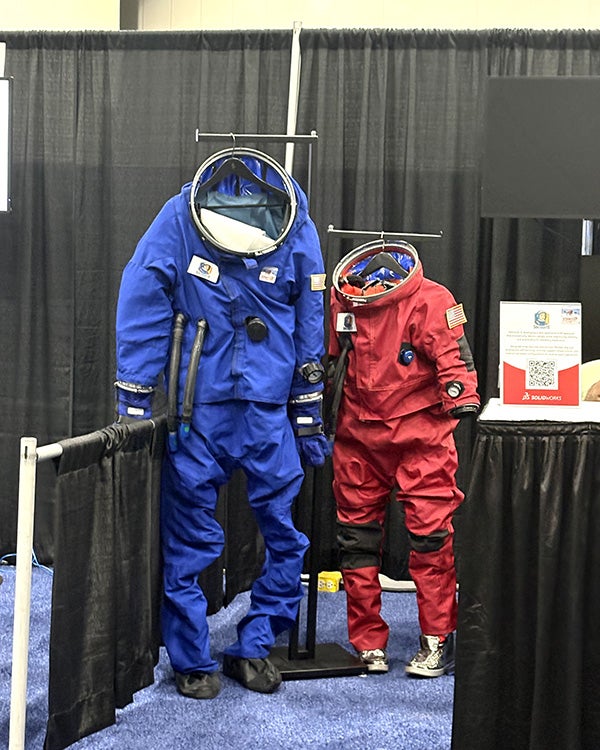 two spacesuits, one red and the other blue