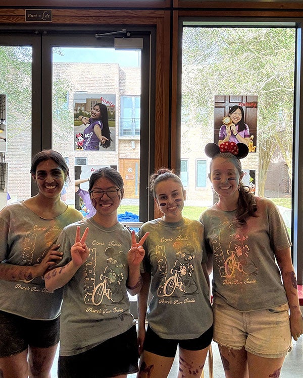 four girls in matching Mickey Mouse costumes