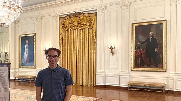 Boy in ornately decorated room