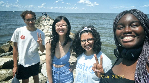 Selfie of four people at seaside 