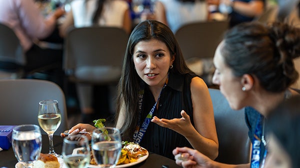 Lady gesturing with a hand while speaking to someone