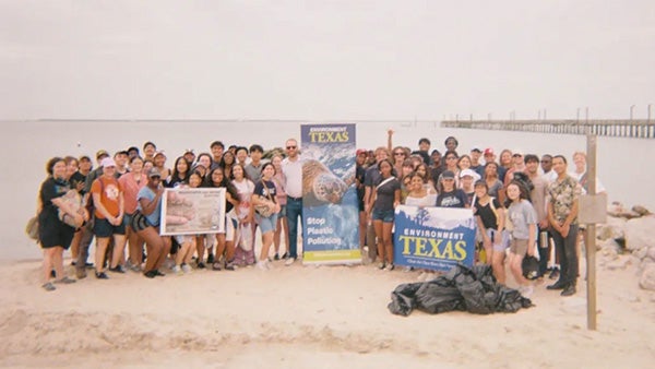 People holding posters on the beach