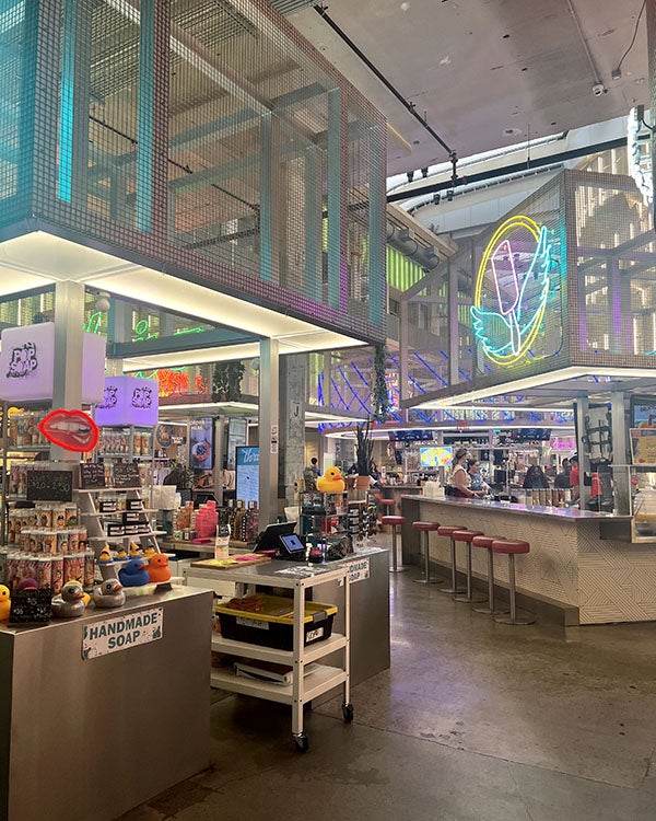 Neon-lit booths in large, open space