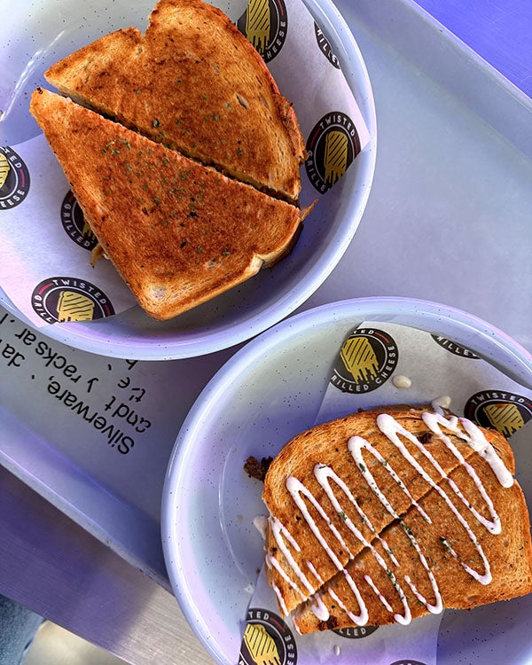 Sandwiches cut diagonally into sandwiches on plates and napkins