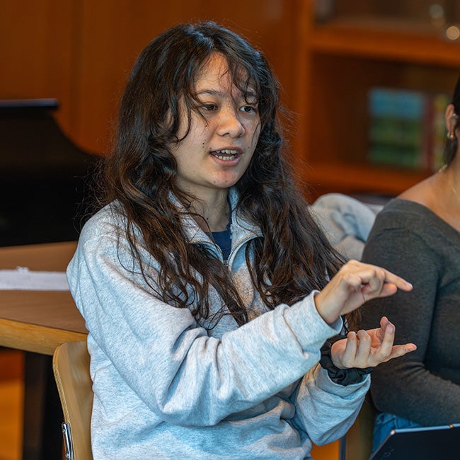 A girl gesturing mid-speech
