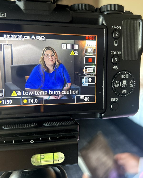 a camera with a woman in the preview panel