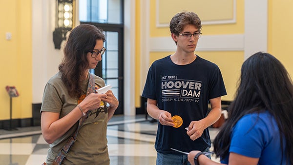 Two people speaking with someone