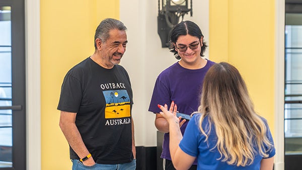 Two people speaking with someone
