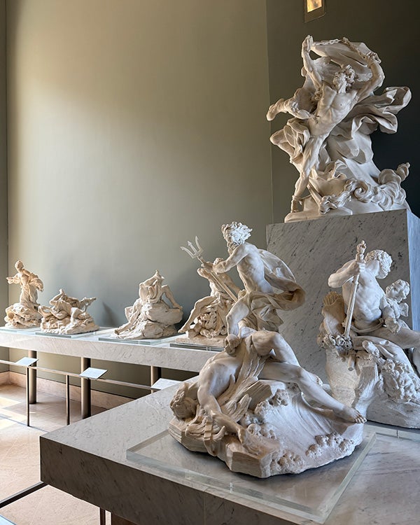 Dozens of small marble sculptures on a table
