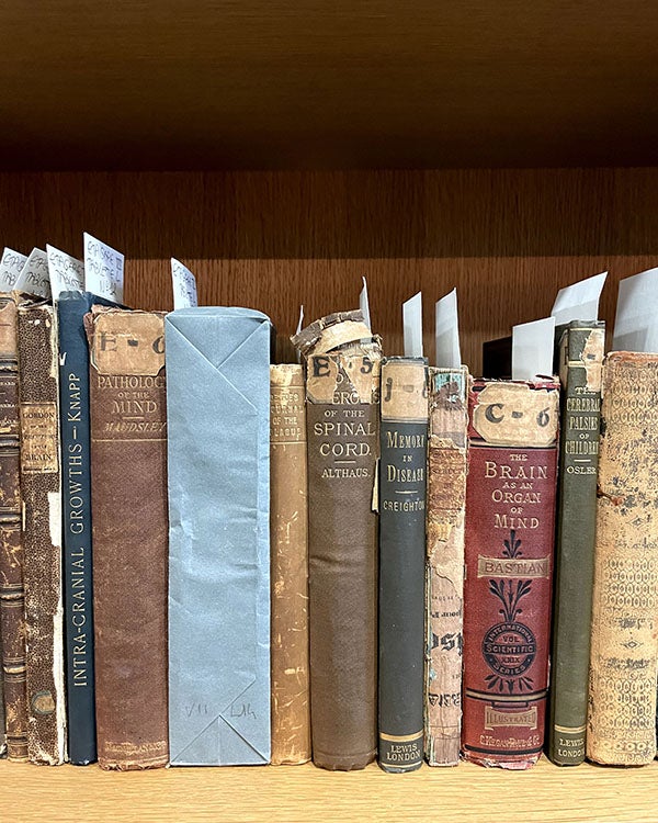 Books about anatomy stacked together on a shelf