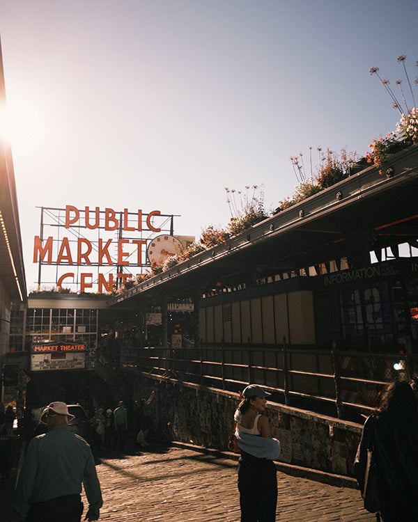 Moody shot of a sign displaying the words "PUBLIC MARKET CENTER" 