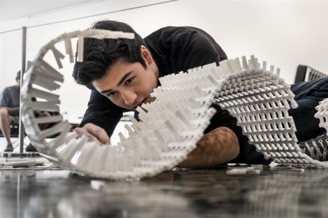 Student looking at a model for a building