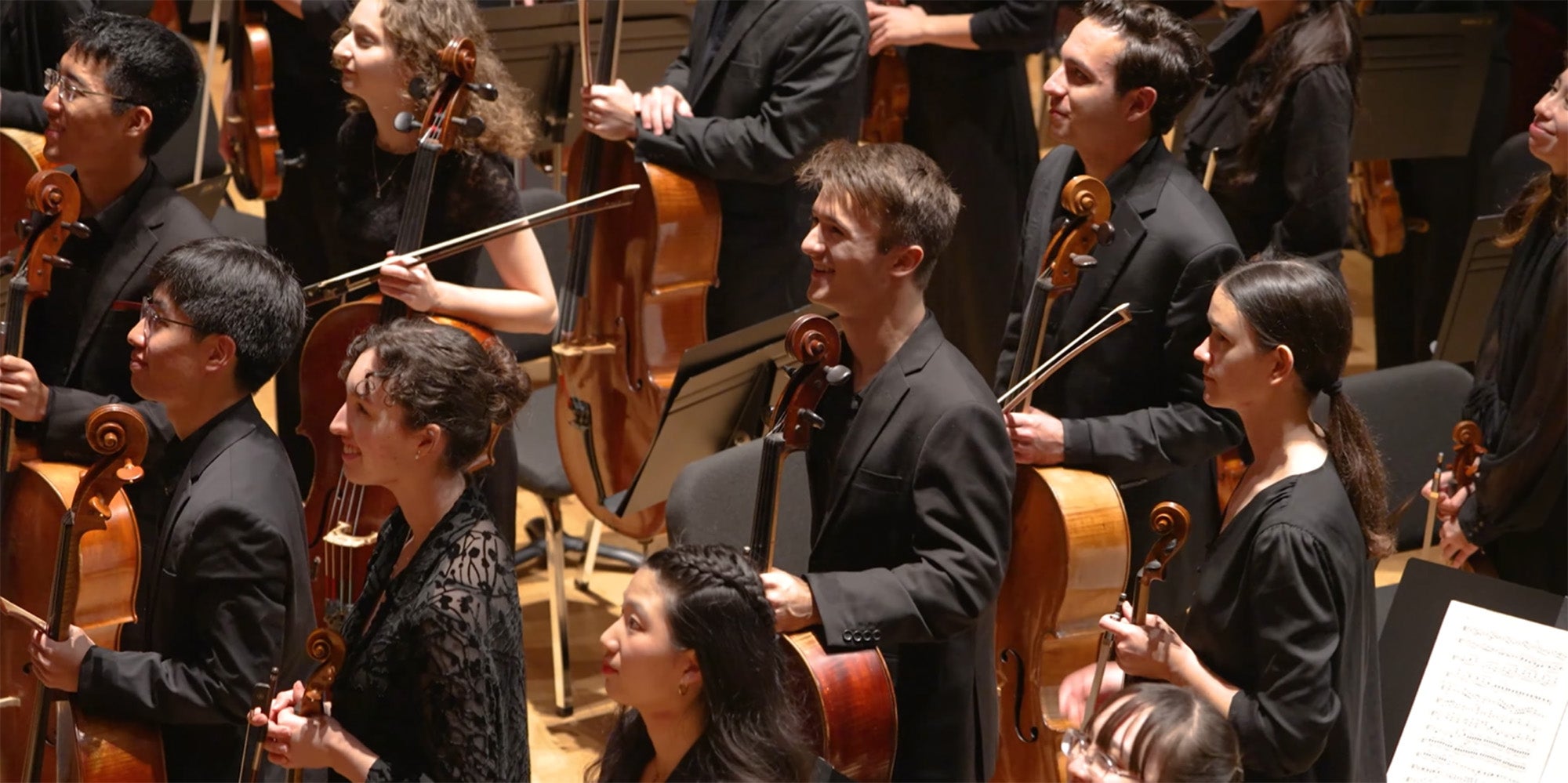 Orchestra ensemble holding instruments