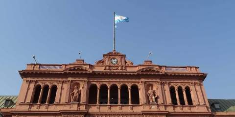 A picture of an official building in Buenos Aires, Argentina, with the Argentinian flag flying above.