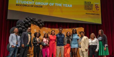 ROC-U students standing on a stage receiving an award