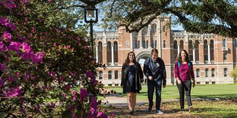 3 Rice students walking on a college campus 