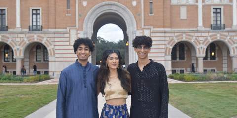 3 students in traditional Indian clothing posing for a photo
