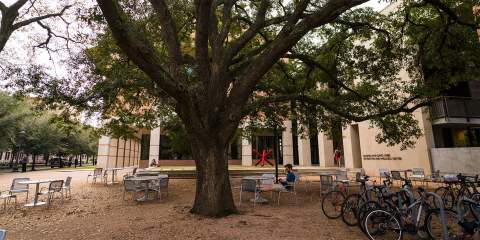 Student working outside of the Gibbs Rec Center building.