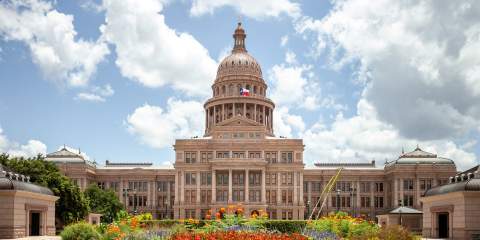 A photo of the Texas state capitol on a sunny day.