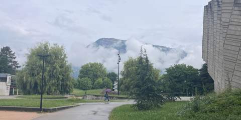 A far-off view of the Grenoble Alpes in France shrouded in clouds