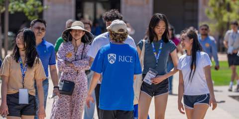 Students follow an Owl Guide on a tour of Rice University.