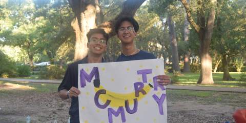 Two students holding up a sign with McMurtry in big letters