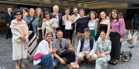 A large group of people in professional attire photographed together