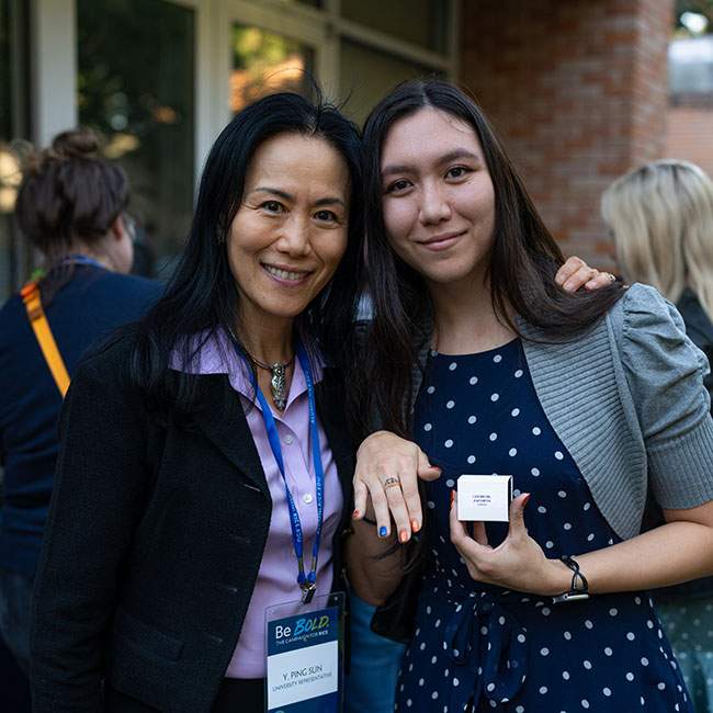 A female Rice student, Kathryn Leebron, shows off her class ring as she stands next to her mom, Y. Ping Sun.