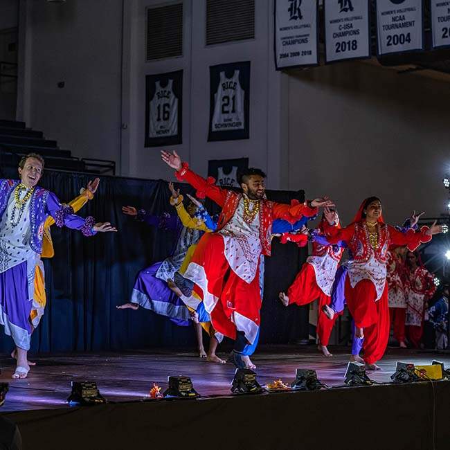 An action shot of a group of students from Rice Bhangra performing at Dhamaka.