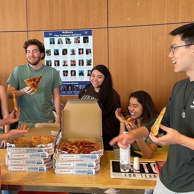McMurtry college students take a study break to eat pizza after class. 