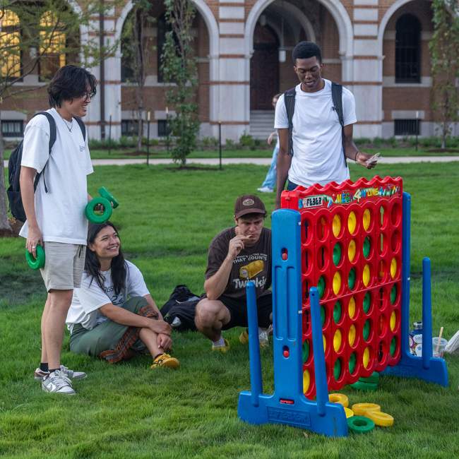 Students play Connect Four on the new lawn in the Academic Quad.