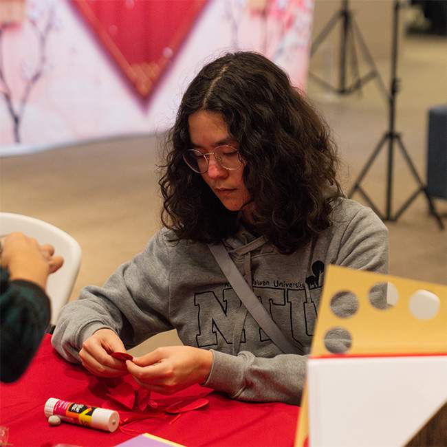 A student holding red paper